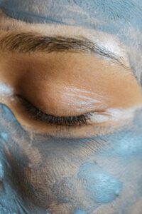 Skincare Closeup. Using an activated charcoal mask to purify skin.